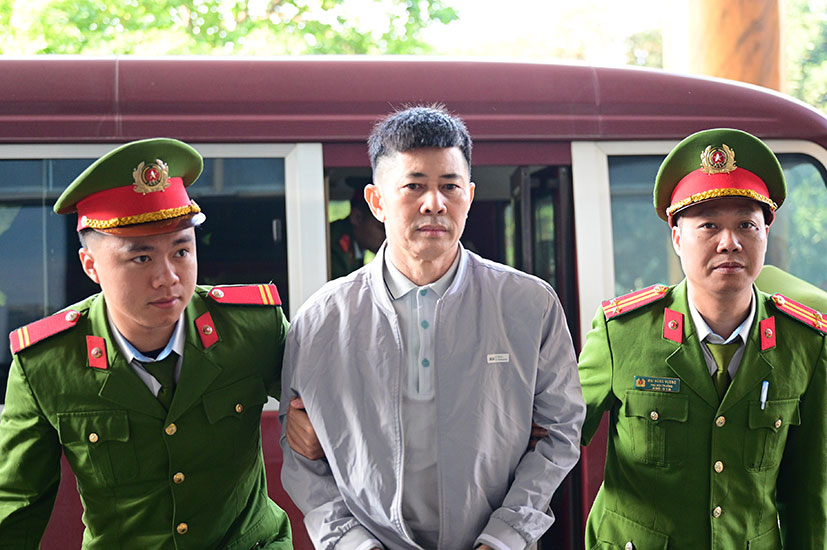 Lực lượng chức năng dẫn giải bị cáo Nguyễn Duy Hưng - cựu Chủ tịch Hội đồng quản trị Tập đoàn Thuận An vào phòng xử án. Ảnh: Quang Việt